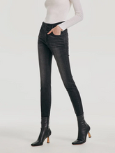 a lady in a gray high waisted stretch denim leggings